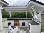 Massive Außenküche in L-Form mit Überdachung